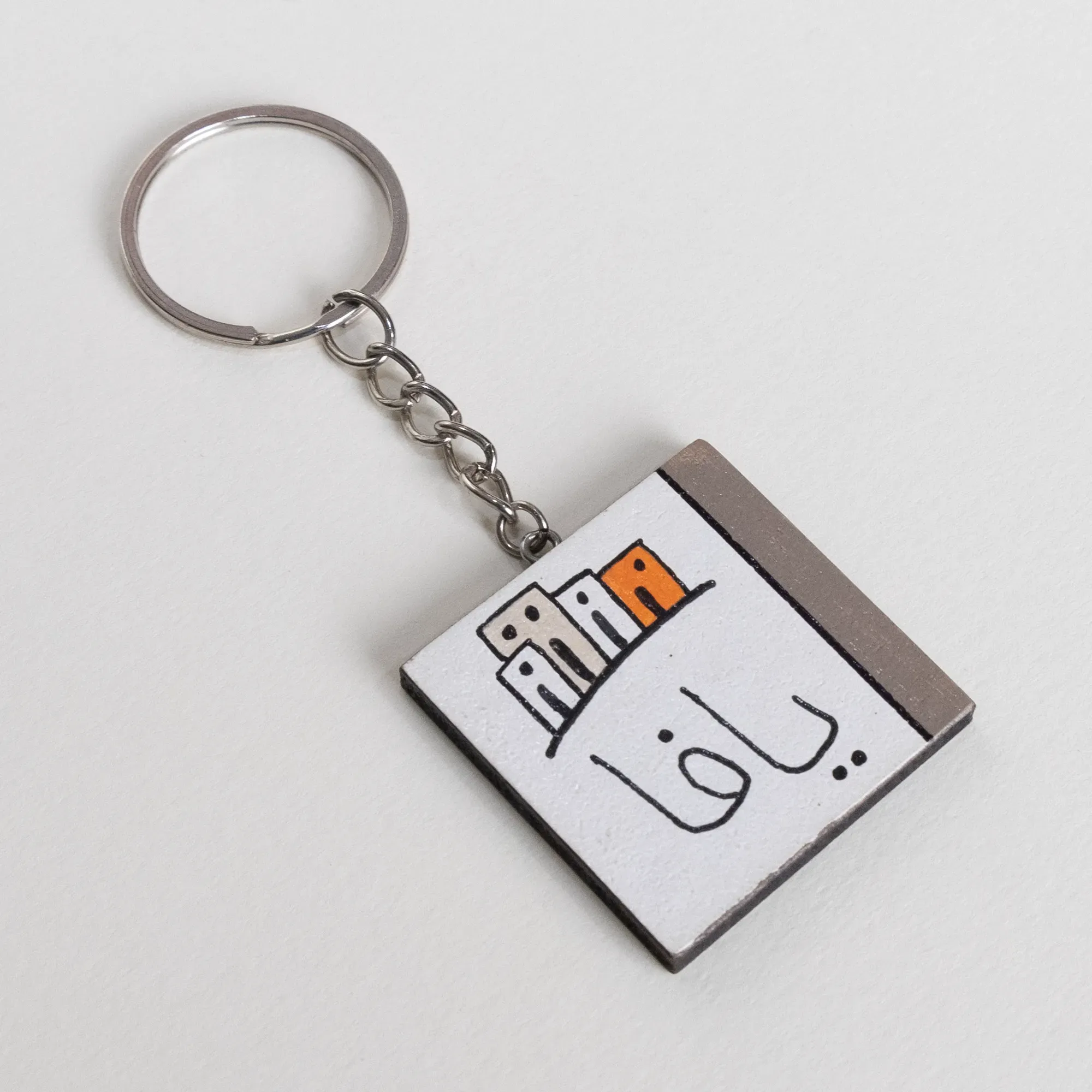 Personalized Wooden Arabic Name Keychain with Small Grey Skyline - 4 x 4 cm