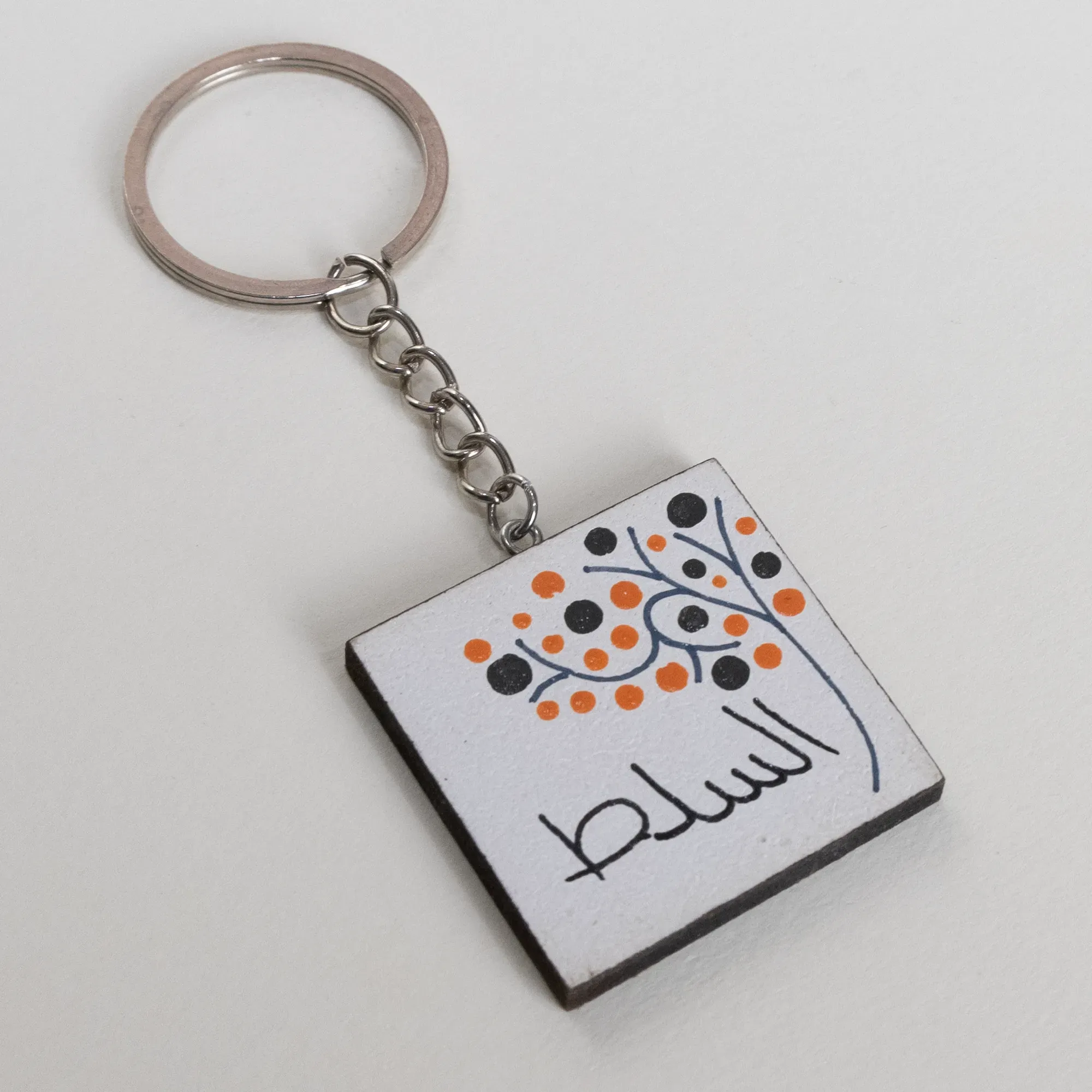 Personalized Wooden Arabic Name Keychain with Orange Blue Dot Spray - 4 x 4 cm