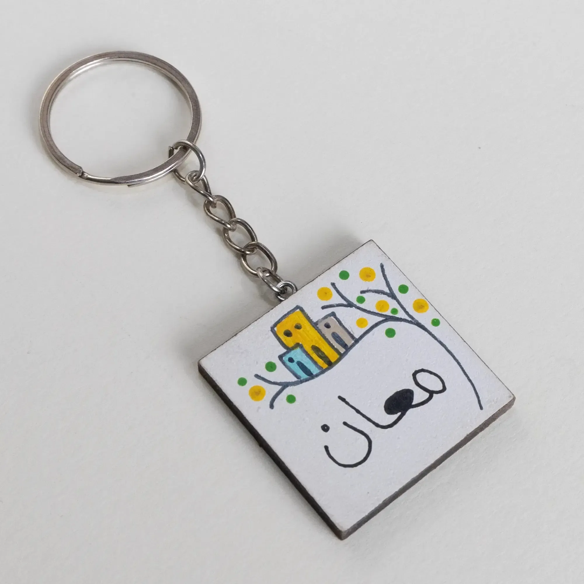 Personalized Wooden Arabic Name Keychain with Yellow Starburst - 4 x 4 cm