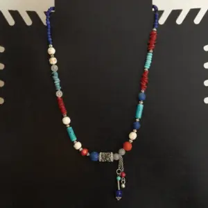 Handcrafted Bohemian Necklace in coral, beads with Distinctive Detail